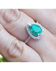 1.39 ct. teardrop emerald ring with diamond halo on a 14K white gold band.