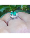 1.39 ct. teardrop emerald halo ring in 14K white gold with natural diamonds.