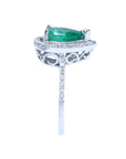 Side profile top emerald setting and galley perspective with band design ring.