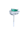1.39 ct. teardrop emerald ring with diamond halo on 14K white gold band.