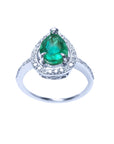 A teardrop natural emerald encircled in a halo diamond crafted in white gold topside view.