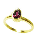 14K yellow gold solitaire ring with a vibrant teardrop natural ruby.