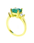 A ladies emerald ring in 18k yellow gold shows the half side profile.