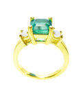 A 18k Yellow gold emerald and princess cut side diamonds ring on its lateral top and gallery profile view.