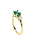 1.01 ct rectangular emerald ring with two diamond accents in 14K yellow gold.
