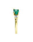 1.01 ct rectangular emerald ring with diamond accents set in 14K yellow gold.