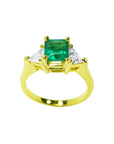 1.27 ct natural Colombian emerald three-stone ring with trillion diamonds in 18K yellow gold.