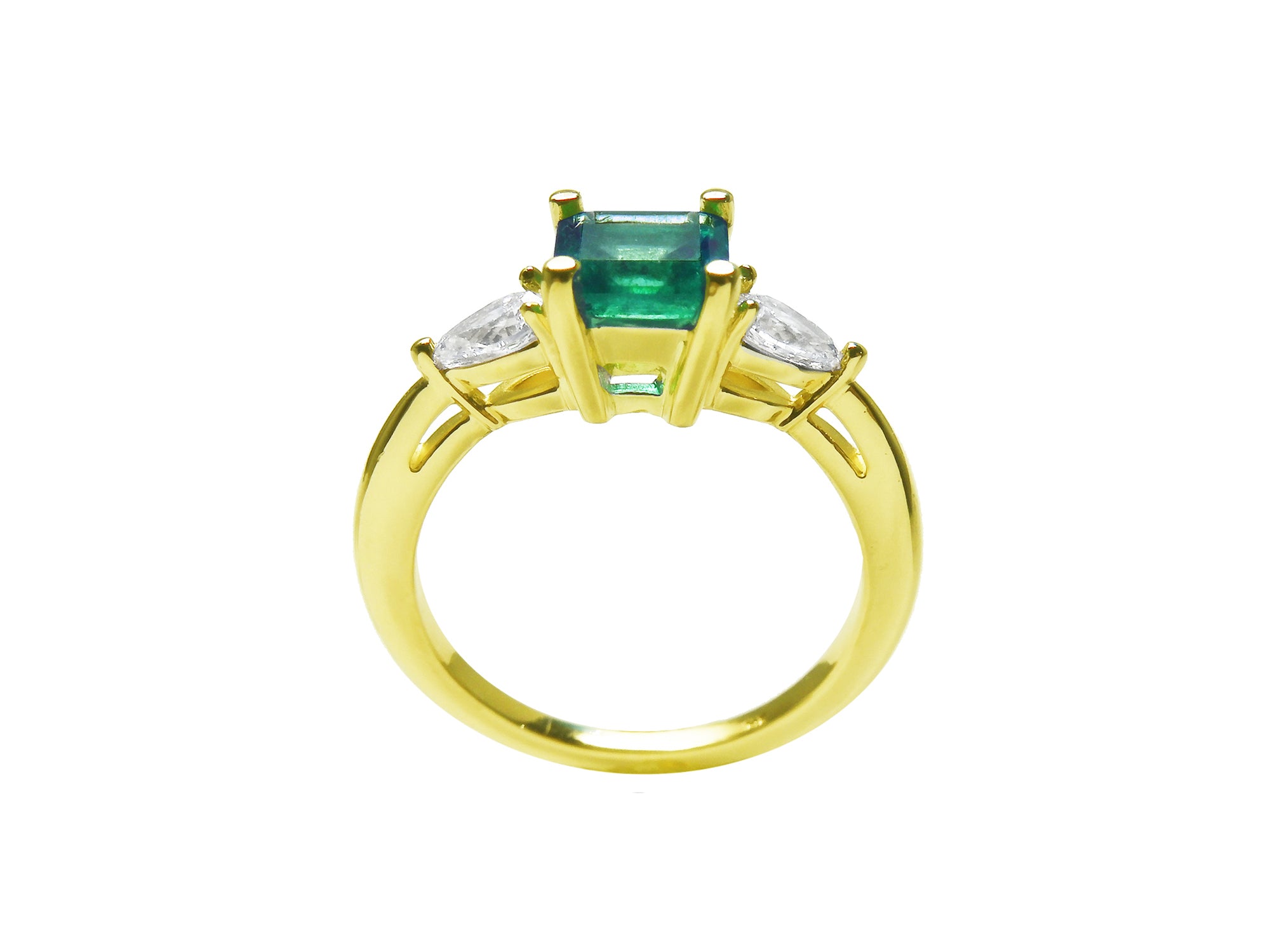 Gold ring with a natural emerald and side diamond, top and lateral profile visibles.