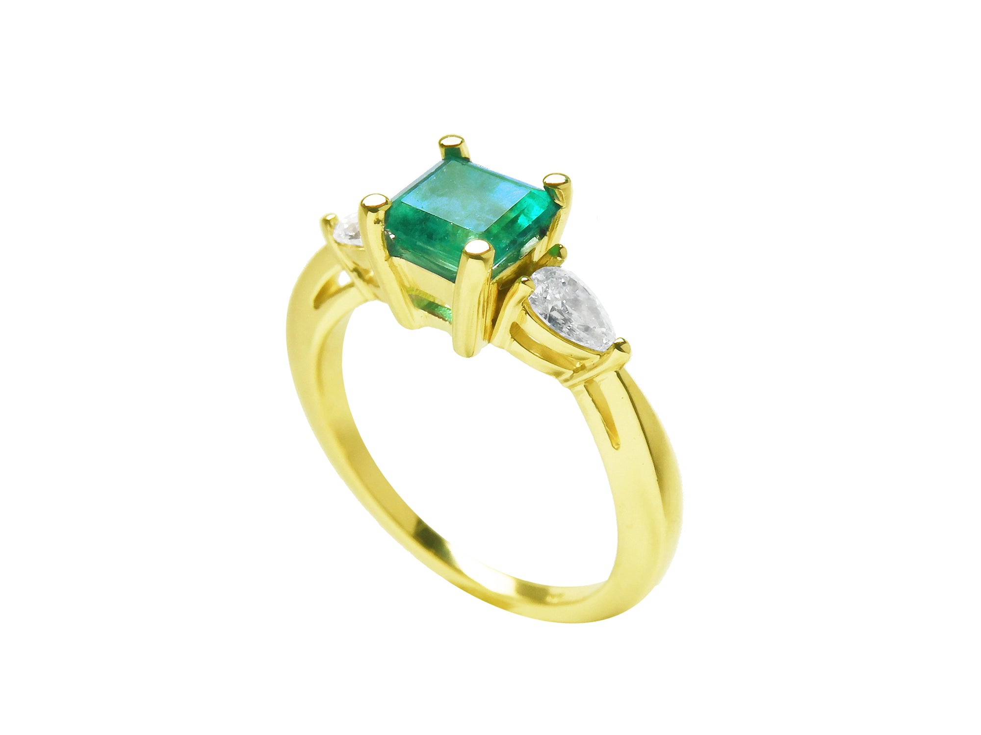 The half side profile of a yellow gold emerald and side diamond ring.