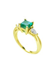 14K yellow gold three-stone ring with a vibrant emerald and two pear-shaped diamonds.