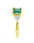 The side of this three stone ring for Mother's Day shows the top emerald and side diamond whit the band's ring.