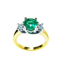 This 14k gold round emerald and side diamonds ring is on a top and lateral profile display.