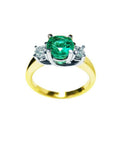 1.12 ct. round cut three stone emerald and diamond ring in 14k white and yellow gold.
