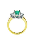 1.12 ct. round cut three stone emerald ring with side diamonds in 14k white and yellow gold.