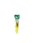 A side profile of this gold ring with a round emerald and smaller diamonds on a white background.
