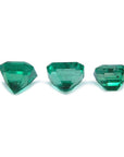 Three stone natural loose emeralds set square, underside girdles and pavilions visibles