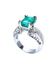 Anillo de oro blanco 18K con esmeralda colombiana rectangular verde profundo y diamantes, estilo antiguo.