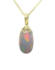 Ethiopian Welo opal pendant with vibrant red fire, set in 14k yellow gold on a delicate chain.