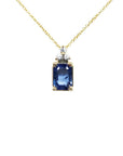 14k gold necklace with an emerald-cut blue sapphire pendant and three accent diamonds.