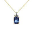 14k gold necklace with an emerald-cut blue sapphire pendant and three accent diamonds.