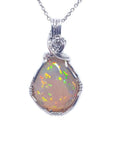 Welo Ethiopian multicolor opal pendant, teardrop shape, with silver wire wrap setting and chain.