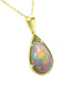 Opal pendant necklace on a gold chain topside view against a white background.