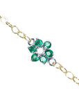 Emerald cluster bracelet with center diamond, crafted in 14k white and yellow gold on a topside view.