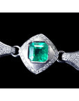 18K white gold emerald and pearl bracelet with a bezel-set Colombian emerald and diamond accents.