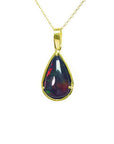 Pear-shaped Welo black opal pendant with red-orange fire and bluish-green flashes, set in 14K yellow gold.