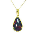 Pear-shaped Welo black opal pendant with red-orange fire and bluish-green flashes, set in 14K yellow gold.