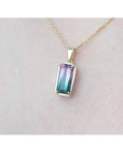 2.50 ct. watermelon tourmaline solitaire pendant with pink and blue-green hues in 14K yellow gold.