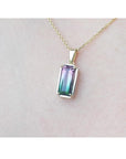 2.50 ct. watermelon tourmaline solitaire pendant with pink and blue-green hues in 14K yellow gold.