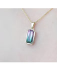 2.50 ct. watermelon tourmaline solitaire pendant with pink and blue-green hues in 14K yellow gold.