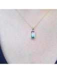 2.50 ct. watermelon tourmaline solitaire pendant necklace in 14K yellow gold, worn on a person.