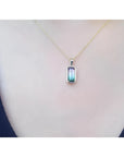 2.50 ct. watermelon tourmaline solitaire pendant necklace in 14K yellow gold, worn on a person.