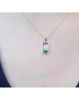 2.50 ct. watermelon tourmaline solitaire pendant necklace in 14K yellow gold, worn on a person.