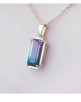 2.50 ct. watermelon tourmaline solitaire pendant with pink and blue-green hues in 14K yellow gold.