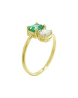 A yellow gold ring featuring a rectangular emerald-cut gemstone and a round clear stone, set on a polished gold band.