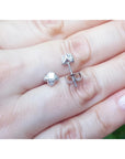 White gold tulip diamond stud earrings with round-cut diamonds and accent diamond petals.
