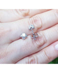White gold tulip diamond stud earrings with round-cut diamonds and accent diamond petals.
