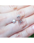 White gold tulip diamond stud earrings with round-cut diamonds and accent diamond petals.
