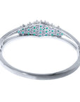 14k white gold bangle bracelet with round Colombian emeralds and diamonds.