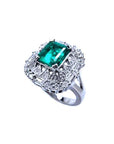A unique vintage emerald ring with baguette and round diamonds, showing the topside and side profile.
