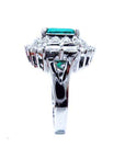 Side profile of a Colombian emerald vintage ring on a white background.