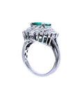 Vintage 14K white gold ring with a large green Colombian emerald and diamond accents.