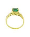Vintage 14K yellow gold ring with a sparkling emerald cut Colombian emerald and accent diamonds.
