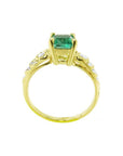 Vintage 14K yellow gold ring with a sparkling emerald cut Colombian emerald and accent diamonds.