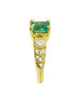 Side accent natural diamonds with top natural colombian emerald ring in 14l yellow gold.