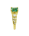 Vintage 14K yellow gold ring with a rectangular emerald and accent diamonds.