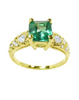 A vintage natural colombian emerald ring for women with accent diamonds crafted in 14k yellow gold.
